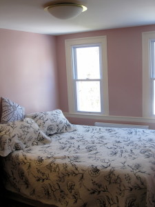 This modestly-sized bedroom has a double bed and two west-facing windows that get bright afternoon sun. 