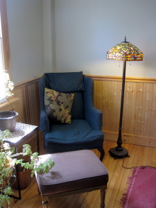 A comfy reading corner in the front parlor. The dining room table (not shown) is to the right.